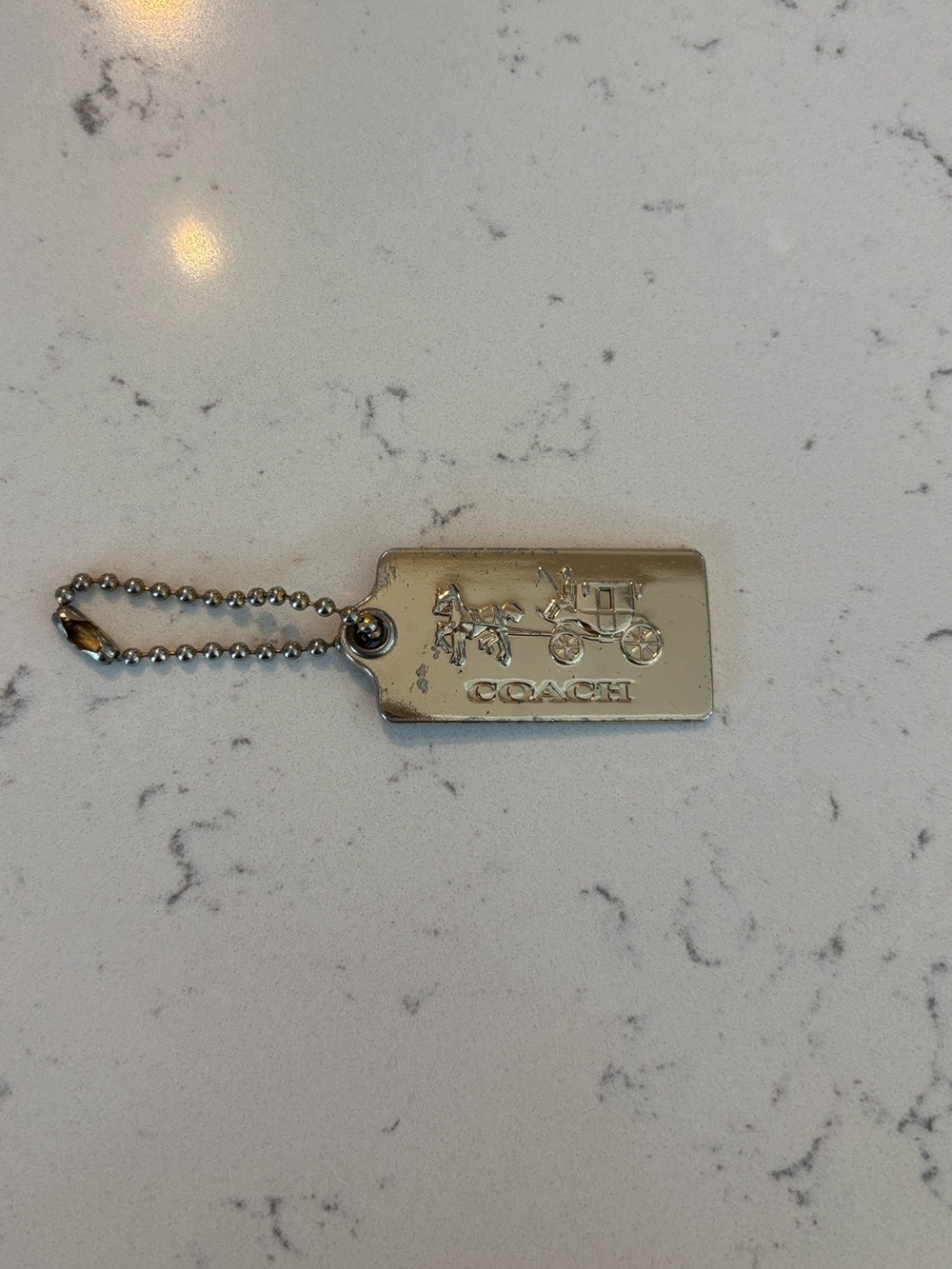 Coach Gold-Tone HangTag with Carriage Logo